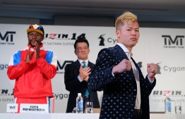 This handout photograph taken by Rizin Fighting Federation on November 5, 2018 shows Japanese kickboxer Tenshin Nasukawa (R) posing during a press conference in Tokyo to announce his fight with US boxer Floyd Mayweather Jr. - Boxing superstar Floyd Mayweather Jr. PHOTO: AFP