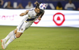 (FILES) In this file photo taken on July 29, 2018  Zlatan Ibrahimovic #9 of the Los Angeles Galaxy heads the ball into the goal at StubHub Center in Carson, California. - Sweden's Zlatan Ibrahimovic, England's Wayne Rooney and Venezuelan striker Josef Martinez were among five finalists named October 31, 2018 for Major League Soccer's 2018 Most Valuable Player Award. Hours before the North American league began its playoff championship run, the league announced finalists for its season awards, topped by the MVP race, which also includes Mexico's Carlos Vela and Paraguayan midfielder Miguel Almiron. (Photo by Katherine LOTZE / GETTY IMAGES NORTH AMERICA / AFP)