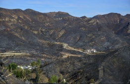 A canyon home was left untouched amid the surrounding charred and blackened hillsides from the Woolsey Fire along Lobo Canyon Road in Agoura Hills, California, destroyed by the Woolsey Fire and as seen on November 15, 2018. - Much of the area remain under evacuation one week after the Woolsey Fire started. (Photo by Frederic J. BROWN / AFP)