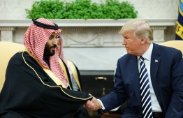 (FILES) In this file photo taken on March 20, 2018 US President Donald Trump (R) shakes hands with Saudi Arabia's Crown Prince Mohammed bin Salman in the Oval Office of the White House in Washington, DC. - US President Donald Trump has accused Saudi Arabia of lying about the killing of Jamal Khashoggi, his strongest comments to date on the affair as pressure builds on the administration to strike a tougher line. In an interview with the Washington Post published late October 20, 2018, Trump stepped back from his stance that Saudi Arabia's latest explanation for the death of the journalist inside their consulate in Istanbul was credible, but said he remained confident in the leadership of Crown Prince Mohammed bin Salman. (Photo by MANDEL NGAN / AFP)
