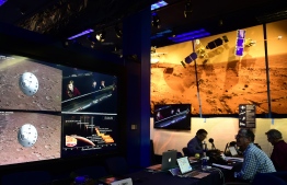 People watch the landing of NASA's InSight spacecraft on the planet Mars on television screens at NASA's Jet Propulsion Laboratory (JPL) in Pasadena, California on November 26, 2018. - Cheers and applause erupted at NASA's Jet Propulsion Laboratory as a $993 million unmanned lander, called InSight, touched down on the Red Planet and managed to send back its first picture. (Photo by Frederic J. BROWN / AFP)