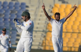 Pakistani spinner Bilal Asif (R) celebrates after taking the wicket of New Zealand batsman Tim Southee during the first day of the third and final Test match between Pakistan and New Zealand at the Sheikh Zayed International Cricket Stadium in Abu Dhabi on December 3, 2018. (Photo by AAMIR QURESHI / AFP)