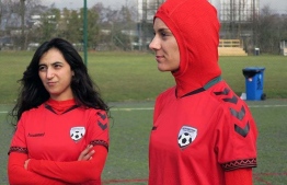 Afghani national soccer team player Shabnam Mabarz, right, stands next to Khalida Popal. PHOTO: DAWN