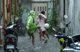 Kids playing football on a flooded street in Male' on November 5. PHOTO: HUSSAIN WAHEED/MIHAARU