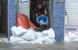 A man bailing out floodwater during the flooding of Male' on November 5. PHOTO: AHMED NISHAATH/MIHAARU