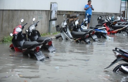 Motorcycles flooded halfway on a street in Male' on November 5. PHOTO: AHMED NISHAATH/MIHAARU