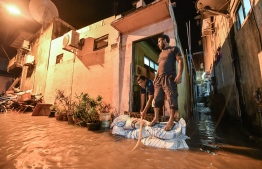 A man pumps water from a flooded home in Male' on November 5. PHOTO: NISHAN ALI/MIHAARU