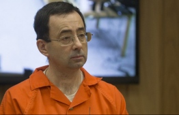 (FILES) In this file photo taken on February 5, 2018 former Michigan State University and USA Gymnastics doctor Larry Nassar appears in court for his final sentencing phase in Eaton County Circuit Court in Charlotte, Michigan. - USA Gymnastics said on December 5, 2018, it had filed for bankruptcy protection as the embattled governing body continues to grapple with the aftermath of the Larry Nassar abuse scandal. In a statement on the organization's website, USA Gymnastics said it had filed for Chapter 11 bankruptcy in Indiana in order to settle lawsuits brought by Nassar's victims. (Photo by RENA LAVERTY / AFP)