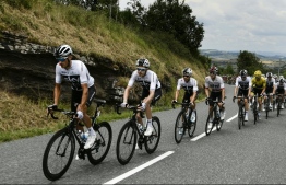 (FILES) In this file photo taken on July 22, 2018 Great Britain's Team Sky cycling team teammates (From L) Italy's Gianni Moscon, Great Britain's Luke Rowe, Spain's Jonathan Castroviejo, Poland's Michal Kwiatkowski, Netherlands' Wout Poels. Great Britain's Geraint Thomas, wearing the overall leader's yellow jersey, Great Britain's Christopher Froome and Colombia's Egan Bernal ride during the 15th stage of the 105th edition of the Tour de France cycling race, between Millau and Carcassonne on July 22, 2018. - British media giant Sky on December 12, 2018 said it would axe its sponsorship of cycling giant Team Sky after next season, ending a partnership that has delivered six Tour de France titles in the past seven years. (Photo by Philippe LOPEZ / AFP)