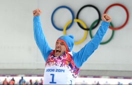 (FILES) In this file photo taken on February 13, 2014, bronze medalist Russia's Evgeniy Garanichev celebrates during the Men's Biathlon 20 km Individual Flower Ceremony at the Laura Cross-Country Ski and Biathlon Center during the Sochi Winter Olympics in Rosa Khutor near Sochi. - Austrian prosecutors announced on December 13, 2018 that members of Russia's biathlon team are being investigated over alleged doping offences dating back to the World Championships in 2017 in the Austrian town of Hochfilzen. Garanichev said: "I am on the list of people suspected of breaking anti-doping rules!! Another scandal!!! We are clean..." (Photo by Kirill KUDRYAVTSEV / AFP)