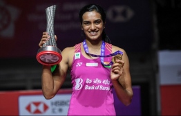 Winner Sindhu Pusarla of India poses with her trophy after the women's singles final match at the 2018 BWF World Tour Finals badminton competition in Guangzhou in southern China's Guangdong province on December 16, 2018. (Photo by STR / AFP) / 