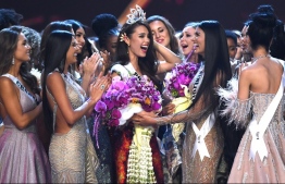 Catriona Gray of the Philippines (C) is congratulated by contestants after winning the Miss Universe 2018 on December 17, 2018 in Bangkok. (Photo by Lillian SUWANRUMPHA / AFP)