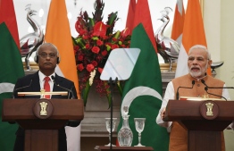 Maldives President Ibrahim Mohamed Solih (L) listens as India Prime Minister Narendra Modi (R) delivers his speech during a ceremony in New Delhi on December 17, 2018. - Maldivian President is on three-day of state visit to India till December 18. (Photo by Prakash SINGH / AFP)