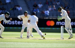 India's Murali Vijay (C) is clean bowled as Australia's wicketkeeper Tim Paine (R) celebrates during day four of the second Test cricket match between Australia and India in Perth on December 17, 2018. (Photo by WILLIAM WEST / AFP) / -- IMAGE RESTRICTED TO EDITORIAL USE - STRICTLY NO COMMERCIAL USE --