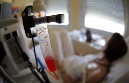 FILE PHOTO: A patient receives chemotherapy treatment for breast cancer at the Antoine-Lacassagne Cancer Center in Nice July 26, 2012. REUTERS/Eric Gaillard