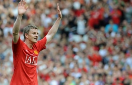 (FILES) In this file photo taken on August 02, 2008 Ole Gunnar Solskjaer of Manchester United waves to the fans at the final whistle after his testimonial football match between Manchester United and Espanyol at Old Trafford, in Manchester, north-west England. - Ole Gunnar Solskjaer was on December 19, 2018, named as Manchester United's caretaker manager until the end of the 2018/19 season following the sacking of Jose Mourinho. The former United striker will take charge of the first team with immediate effect and will remain in place while the club looks for a new full-time manager. (Photo by Andrew YATES / AFP)