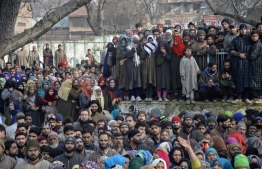 Kashmiri villagers gather near the bodies of slain militants of Ansar Ghazwat-ul-Hind, a group which claims affiliation with Al-Qaeda, during a funeral procession at Dadsar village in Tral, south of Srinagar on December 22, 2018. - Soldiers on December 22 killed six militants from a group believed to be an affiliate of Al-Qaeda in Indian-administered Kashmir during a brief firefight, officials said, sparking clashes between protestors and police. (Photo by TAUSEEF MUSTAFA / AFP)