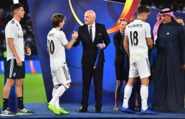 FIFA president Gianni Infantino (3rd-L) shakes hands with Real Madrid's Croatian midfielder Luka Modric (2nd-L) after the FIFA Club World Cup final football match Spain's Real Madrid vs Abu Dhabi's Al Ain at the Zayed Sports City Stadium in Abu Dhabi, the capital of the United Arab Emirates, on December 22, 2018. (Photo by Giuseppe CACACE / AFP)