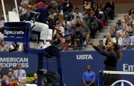 (FILES) In this file photo taken on September 8, 2018 Serena Williams of the US argues with chair umpire Carlos Ramos while playing Naomi Osaka of Japan during their 2018 US Open women's singles final match  in New York. - Osaka, 20, triumphed 6-2, 6-4 in the match marred by Williams's second set outburst, the American enraged by umpire Carlos Ramos's warning for receiving coaching from her box. She tearfully accused him of being a "thief" and demanded an apology from the official. (Photo by Eduardo MUNOZ ALVAREZ / AFP)