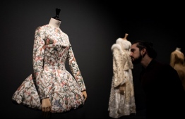 (FILES) In this file photo taken on December 04, 2018 A man looks at a creation by Spanish designer Leandro Cano during the exhibition "Modus", on December 4, 2018 in Madrid. - On display at Sala Canal de Isabel II in Madrid from 4 December to 3 March, the show brings together iconic pieces by designers such as Mariano Fortuny, Cristobal Balenciaga, Manuel Pertegaz, Jesus del Pozo, Paco Rabanne, Sybilla, Ana Locking and Palomo Spain, and explores the influence of Spanish history and tradition on global fashion and how this "Spanishness" is being re-appropriated by young, up-and-coming local designers. (Photo by GABRIEL BOUYS / AFP)