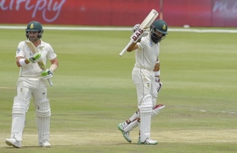 South Africa's Hashim Amla reacts after scoring his fifty runs during day three of the 1st cricket test match between South Africa and Pakistan at SuperSport Park cricket stadium on December 28, 2018 in Pretoria. (Photo by Christiaan Kotze / AFP)