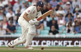 (FILES) In this file photo taken on September 09, 2018 England's Alastair Cook plays a shot, batting in his final Test Match Innings, during play on the third day of the fifth Test cricket match between England and India at The Oval in London on September 9, 2018. - Cook was knighted in the 2019 New Year Honours list. (Photo by Adrian DENNIS / AFP)