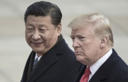 (FILES) In this file photo taken on November 9, 2017, China's President Xi Jinping (L) and US President Donald Trump attend a welcome ceremony at the Great Hall of the People in Beijing. - US President Donald Trump on December 29, 2018 touted "big progress" after a phone call with his Chinese counterpart on trade, after the tariff war between the world's two biggest economies helped rattle markets. (Photo by FRED DUFOUR / AFP)