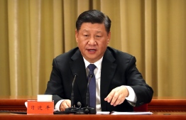 China's President Xi Jinping speaks during an event to commemorate the 40th anniversary of the Message to Compatriots in Taiwan at the Great Hall of the People in Beijing on January 2, 2019. - Taiwan's unification with the mainland is "inevitable", President Xi Jinping said on January 2, warning against any effort to promote the island's independence and saying China would not renounce the option of military force to bring it into the fold. (Photo by Mark Schiefelbein / POOL / AFP)