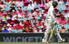 Australia's Usman Khawaja walks off the ground after being dismissed during the third day's play of the fourth and final cricket Test between India and Australia at the Sydney Cricket Ground on January 5, 2019. (Photo by DAVID GRAY / AFP) / 
