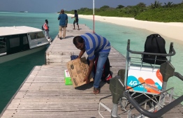 Travellers load luggage on a trolley at the jetty of HDh.Hanimaadhoo. PHOTO/MIHAARU