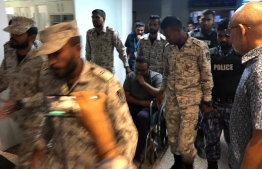 Officers of Maldives Correctional Service and Maldives Police Service escort former Vice President Ahmed Adeeb to IGMH. 