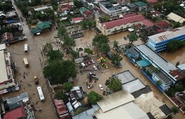 This general view shows a flooded area in the town of Baao in Camarines Sur province on December 30, 2018. - Four people were killed in landslides and thousands of others evacuated from their homes after a storm swept through the central Philippine islands on December 29, officials said. (Photo by Simvale SAYAT / AFP)