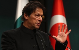 Pakistani Prime Minister Imran Khan gestures during a joint press conference with the Turkish President at the Presidential Complex in Ankara, on January 4, 2019. (Photo by ADEM ALTAN / AFP)