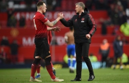 Manchester United's  Norwegian caretaker manager Ole Gunnar Solskjaer (R) greets Manchester United's English defender Phil Jones (L) at the end of the English FA Cup third round football match between Manchester United and Reading at Old Trafford in Manchester, north west England, on January 5, 2019. (Photo by Oli SCARFF / AFP) / RESTRICTED TO EDITORIAL USE. No use with unauthorized audio, video, data, fixture lists, club/league logos or 'live' services. Online in-match use limited to 120 images. An additional 40 images may be used in extra time. No video emulation. Social media in-match use limited to 120 images. An additional 40 images may be used in extra time. No use in betting publications, games or single club/league/player publications. / 