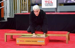 Actor Sam Elliott places his hands in the block of cement during his Hand and Footprints ceremony in Hollywood, California on January 7, 2019. Frederic J. BROWN / AFP