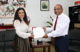 Minister of Foreign Affairs Abdulla Shahid presents the exequatur to Mariyam Waheeda. PHOTO: MINSITRY OF FOREIGN AFFAIRS