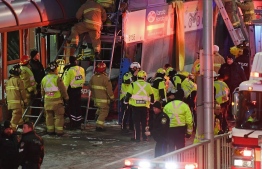Police and first responders work at the scene where a double-decker city bus struck a transit shelter in Ottawa, on Friday, Jan. 11, 2019.Justin Tang / THE CANADIAN PRESS