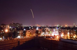 Syrian state media broadcast footage of what it said were its air defences lighting up the night sky in 2019. [Handout/SANA/AFP]
