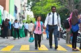 A child goes to school on the first day of the 2019 Academic Year. PHOTO: HUSSAIN WAHEED/ MIHAARU