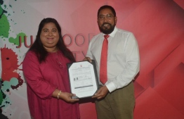 Former Minister of Gender and Social Services Dr Amal Ali presents membership form to JP leader Qasim Ibrahim. PHOTO: JUMHOOREE PARTY