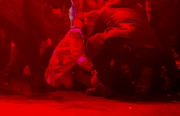 The mayor of Gdansk Pawel Adamowicz lies on the floor and is helped after being attacked during a charity event in Gdansk on January 13, 2019. - The mayor of Gdansk Pawel Adamowicz was attacked by a man who beat him with a knife, the police said, confirming the initial information given by several media outlets. (Photo by Piotr HUKALO / East News / AFP)