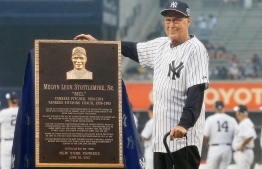 (FILES) In this file photo taken on  June 20, 2015, former New York Yankee player and coach Mel Stottlemyre poses with his plaque that will be placed in Monument Park at Yankee Stadium prior to a game against the Detroit Tigers on in the Bronx borough of New York City. - Stottlemyre, a former Major League Baseball All-Star pitcher who helped the New York Yankees and Mets to World Series titles, died on January 13, 2019, of bone marrow cancer at age 77. Stottlemyre was a 1960s star for the Yankees, dropping the decisive 1964 World Series seventh game against St. Louis Cardinals legend Bob Gibson, and spent 10 years with both New York clubs as a pitching coach. (Photo by Jim McIsaac / GETTY IMAGES NORTH AMERICA / AFP)