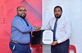 Former Deputy Commissioner of Police, Abdulla Nawaz (L), presents his application to join Jumhooree Party (JP) to the party's leader Qasim Ibrahim. PHOTO: NISHAN ALI/MIHAARU