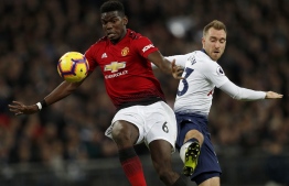 Manchester United's French midfielder Paul Pogba (L) vies with Tottenham Hotspur's Danish midfielder Christian Eriksen (R) during the English Premier League football match between Tottenham Hotspur and Manchester United at Wembley Stadium in London, on January 13, 2019. (Photo by Adrian DENNIS / AFP) / RESTRICTED TO EDITORIAL USE. No use with unauthorized audio, video, data, fixture lists, club/league logos or 'live' services. Online in-match use limited to 120 images. An additional 40 images may be used in extra time. No video emulation. Social media in-match use limited to 120 images. An additional 40 images may be used in extra time. No use in betting publications, games or single club/league/player publications. / 