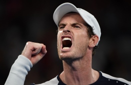 Britain's Andy Murray reacts after a point during his men's singles match against Spain's Roberto Bautista Agut on day one of the Australian Open tennis tournament in Melbourne on January 14, 2019. (Photo by SAEED KHAN / AFP) / 