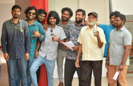A group of youths and an upper middleaged man during the Maldivian Democratic Party parliamentary primaries. PHOTO: AHMED NISHAATH/MIHAARU