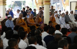 Buddhist monks and Muslim village leaders sit together to express sympathy and support during a gathering in Rattanaupap temple in Narathiwat province on January 19, 2019 following an attack by black-clad gunmen that killed two Buddhist monks. - Gunmen in Thailand's deep south shot dead two Buddhist monks and wounded two others inside a temple, police said January 19, capping a week of deadly violence as the prime minister vowed to "punish" those responsible. (Photo by Madaree TOHLALA / AFP)