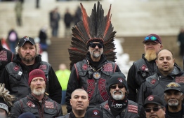 Members of an indigenous bikers group listen to a woman giving them directions to help with security during the Indigenous People's March on the National Mall at the Lincoln Memorial in Washington, DC, on January 18, 2019. (Photo by ANDREW CABALLERO-REYNOLDS / AFP)