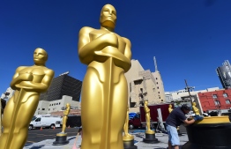 (FILES) In this file photo taken on February 24, 2016 Rick Roberts works on touching up a base amid statues of the Oscar awaiting finishing up at a Hollywood back lot in Hollywood, California ahead this weekend's 88th Academy Awards. - Hollywood's biggest night -- the Oscars -- is set to take place in Febuary 2019 without a host for the first time in 30 years, after comedian Kevin Hart pulled out of the gig and no suitable replacement was found. Though organizers have yet to confirm the plans, entertainment insiders say the show's producers are forging ahead with preparations for the 91st Academy Awards on February 24 with no emcee. (Photo by FREDERIC J. BROWN / AFP)