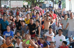 People react as they watch boxing icon Manny Pacquiao of the Philippines fight against opponent Adrien Broner of the US during a live telecast of their WBA welterweight bout in Las Vegas, at a covered sports court in Manila on January 20, 2019. - Pacquiao proved that age is no obstacle on January 19 with a 12-round demolition of Adrien Broner, defending his welterweight title in his first fight on US soil in two years. (Photo by TED ALJIBE / AFP)